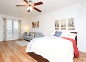 Thumbnail 11 of 16 - a bedroom with a bed and a ceiling fan