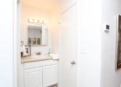 Thumbnail 14 of 16 - a bathroom with a sink and a mirror