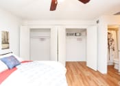 Thumbnail 13 of 16 - a bedroom with a bed and two closets and a bathroom
