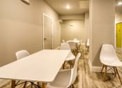 Thumbnail 17 of 27 - a long row of white tables and chairs in a large room