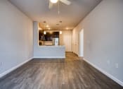 Thumbnail 2 of 27 - a living room with a kitchen and a ceiling fan