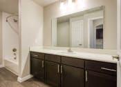 Thumbnail 3 of 27 - a bathroom with a sink and a mirror