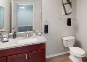 Thumbnail 16 of 20 - Bathroom with toilet, sink and mirror