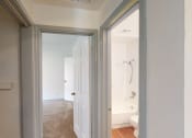 Thumbnail 2 of 43 - a bedroom with a door to a bathroom with a tub and a shower