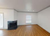 Thumbnail 7 of 43 - the living room of a home with a fireplace and wooden floors