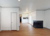 Thumbnail 5 of 43 - a living room with white walls and a fireplace and wooden floors