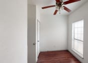 Thumbnail 20 of 43 - an empty room with a ceiling fan and a window