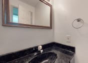 Thumbnail 26 of 43 - a bathroom with a sink and a mirror