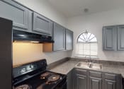 Thumbnail 31 of 43 - a kitchen with a sink and a stove and a window