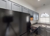 Thumbnail 27 of 43 - a kitchen with stainless steel appliances and granite counter tops