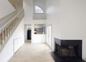 Thumbnail 29 of 43 - a view of the hallway of a house with stairs and a fireplace