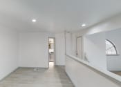 Thumbnail 43 of 43 - a living room with white walls and a window and a staircase