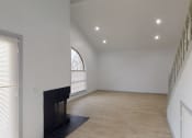 Thumbnail 32 of 43 - a living room with a fireplace and white walls