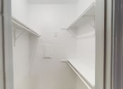 Thumbnail 39 of 43 - a white room with a window and a white shelf in it