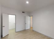 Thumbnail 36 of 43 - a living room with white walls and a wood floor