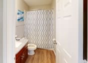 Thumbnail 9 of 20 - a bathroom with a shower and a toilet and a sink