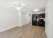 Thumbnail 20 of 39 - a renovated living room and kitchen with wood flooring and a ceiling fan