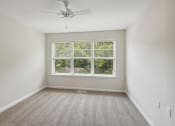 Thumbnail 30 of 39 - an empty room with a window and a ceiling fan