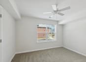 Thumbnail 23 of 39 - an empty room with a large window and a ceiling fan