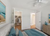 Thumbnail 8 of 19 - a living room with a couch and a ceiling fan