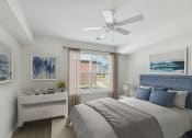 Thumbnail 9 of 39 - a bedroom with a large bed and a ceiling fan