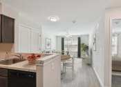 Thumbnail 15 of 19 - a kitchen and living room with a dining area and a living room