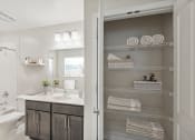 Thumbnail 10 of 19 - a bathroom with a shower and a sink and a mirror