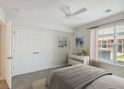 Thumbnail 10 of 39 - a bedroom with a bed and a ceiling fan
