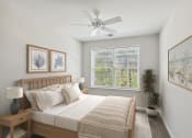 Thumbnail 6 of 19 - a bedroom with a bed and a ceiling fan
