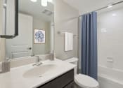 Thumbnail 16 of 39 - a bathroom with a sink and a toilet and a shower