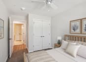 Thumbnail 7 of 19 - a bedroom with a bed and a ceiling fan