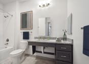 Thumbnail 8 of 14 - a bathroom with a sink and a toilet and a shower