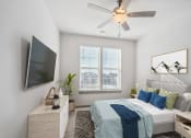 Thumbnail 7 of 14 - a bedroom with a large bed and a ceiling fan