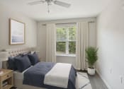 Thumbnail 13 of 39 - a bedroom with a bed and a ceiling fan
