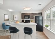 Thumbnail 5 of 39 - a kitchen and living room with a bar and chairs