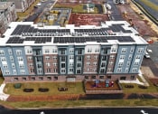 Thumbnail 9 of 14 - an aerial view of an apartment building with solar panels on the roof