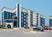 Thumbnail 2 of 18 - a building with cars parked in front of it