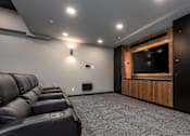 Thumbnail 13 of 18 - a large screening room with couches and a tv
