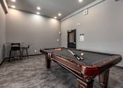 Thumbnail 16 of 18 - a game room with a pool table and a bar