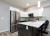 Thumbnail 4 of 18 - a kitchen with stainless steel appliances and a white counter top