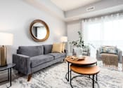 Thumbnail 5 of 18 - a living room with a couch and a coffee table