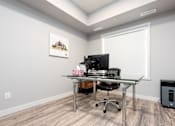 Thumbnail 7 of 18 - a home office with a computer on a desk and a window