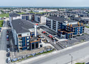 Thumbnail 9 of 18 - an aerial view of a new apartment complex with cars parked in a parking lot