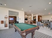 Thumbnail 1 of 26 - a resident clubhouse with a pool table and bar