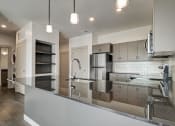 Thumbnail 5 of 26 - a kitchen with a large center island with a sink and a chrome faucet
