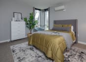 Thumbnail 16 of 28 - a bedroom with a bed and a dresser and a window