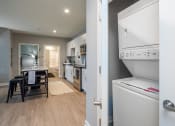 Thumbnail 15 of 28 - a kitchen and dining room with a refrigerator and a table