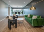 Thumbnail 4 of 28 - a living room with a green couch and two chairs