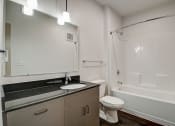 Thumbnail 20 of 26 - a bathroom with a sink toilet and bathtub