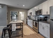 Thumbnail 1 of 28 - a kitchen with stainless steel appliances and a wooden table
